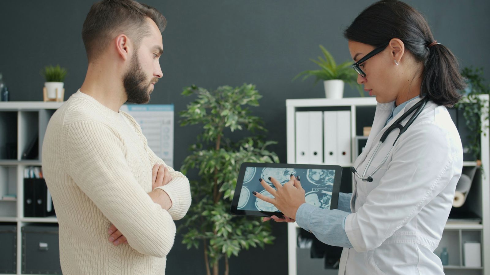 Doctor walking a patient through his 3D scan on a tablet