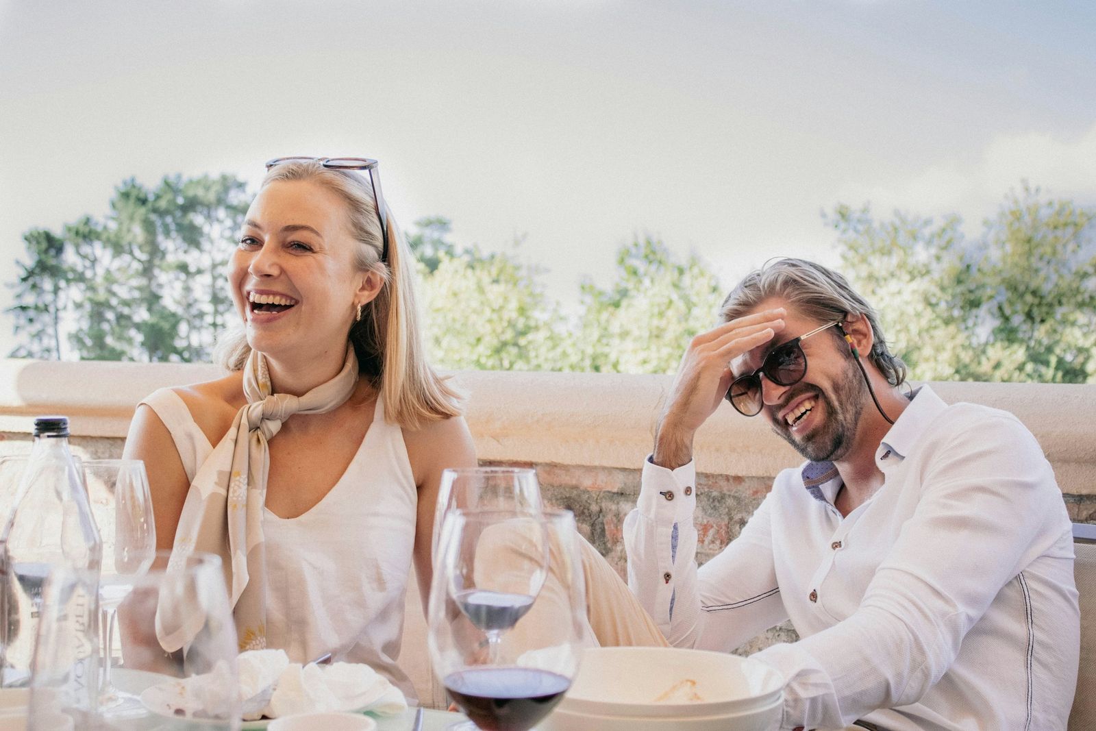 Couple laughing together over lunch outdoors